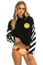 Last inn bildet i Galleri-visningsprogrammet, CAUTION STRIPE SLEEVE SMILEY 2 EMBROIDERY RELAXED CROPPED PULLOVER HOODIE - BLACK // WHITE Hoodie Aviator Nation