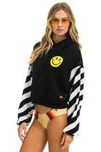 Last inn bildet i Galleri-visningsprogrammet, CAUTION STRIPE SLEEVE SMILEY 2 EMBROIDERY RELAXED CROPPED PULLOVER HOODIE - BLACK // WHITE Hoodie Aviator Nation