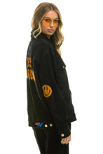 Load image into Gallery viewer, KEEP SMILING OVERSIZED CONCERT DENIM JACKET - VINTAGE BLACK Denim Jacket Aviator Nation
